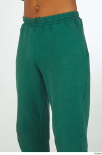 Nathaniel dressed green jogging pants sports thigh 0002.jpg